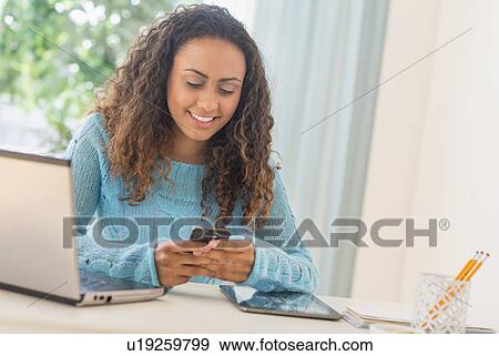 Young woman in home office View Large Photo Image Stock Photo - Young woman in home office. Fotosearch