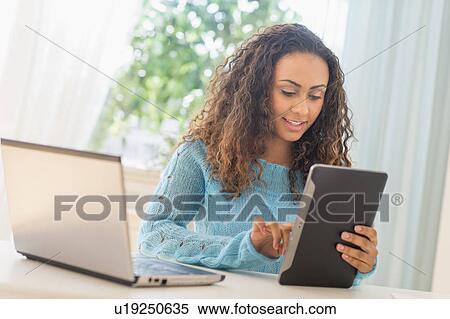 Young woman in home office View Large Photo Image Stock Photography - Young woman in home office. Fotosearch