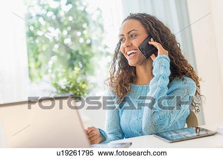 Young woman in home office View Large Photo Image Stock Photography - Young woman in home office. Fotosearch