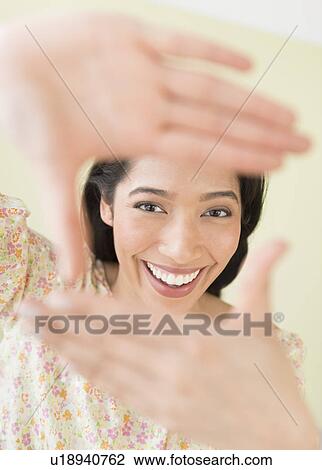 Young woman looking through hand frame View Large Photo Image Stock Image - Young woman looking through hand frame. Fotosearch