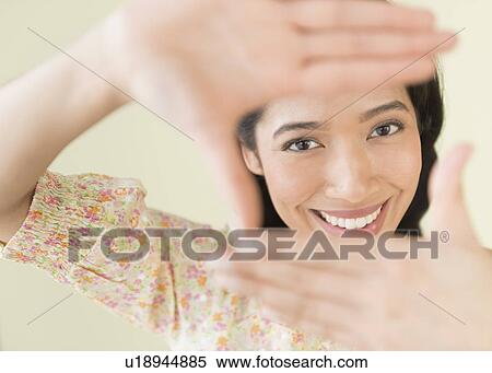Young woman looking through hand frame View Large Photo Image Stock Photography - Young woman looking through hand frame. Fotosearch