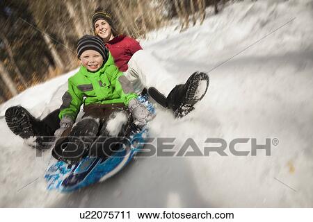 Young woman sledding with boy (4-5) View Large Photo Image Stock Image - Young woman sledding with boy (4-5). Fotosearch
