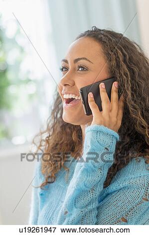 Young woman talking on phone View Large Photo Image Stock Photo - Young woman talking on phone. Fotosearch