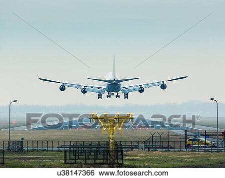 Stock Photograph - Aeroplane coming in to land, Amsterdam airport Shiphol. Fotosearch