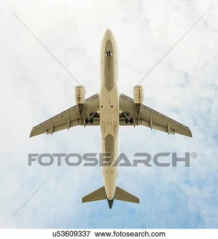 Aeroplane flying, view from below View Large Photo Image Stock Photo - Aeroplane flying, view from below. Fotosearch