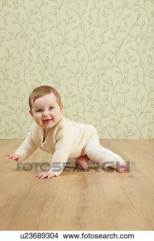 Baby girl crawling on floor View Large Photo Image Picture - Baby girl crawling on floor. Fotosearch