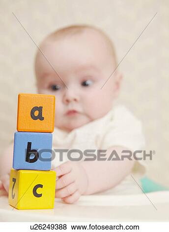 Baby girl with alphabet blocks View Large Photo Image Stock Photo - Baby girl with alphabet blocks. Fotosearch