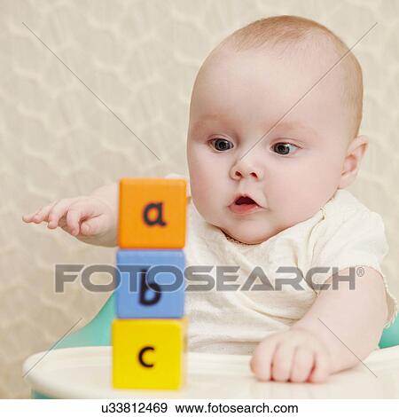 Baby girl with alphabet blocks View Large Photo Image Stock Photo - Baby girl with alphabet blocks. Fotosearch