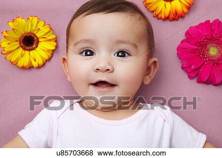 Stock Photo - Baby girl with flowers. Fotosearch