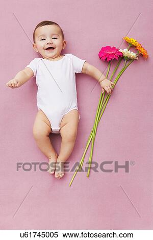 Baby girl with gerbera flowers View Large Photo Image Stock Photography - Baby girl with gerbera flowers. Fotosearch