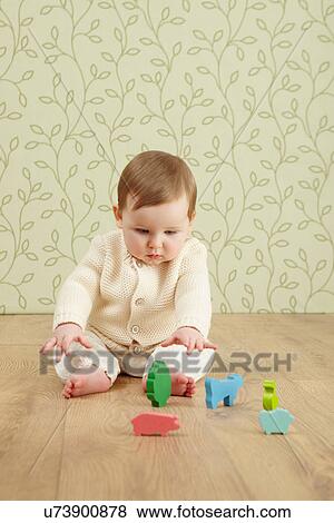 Baby girl with toy animals View Large Photo Image Stock Photo - Baby girl with toy animals. Fotosearch