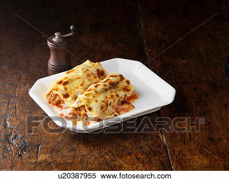 Beef Cannelloni on white rectangular plate with wooden pepper grinder View Large Photo Image Stock Photography - Beef Cannelloni on white rectangular plate with wooden pepper grinder. Fotosearch