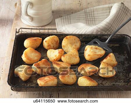 Beef dripping roast potatoes on baking tray and wire rack View Large Photo Image Stock Image - Beef dripping roast potatoes on baking tray and wire rack. Fotosearch