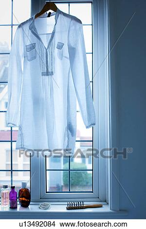 Blouse hanging in window View Large Photo Image Picture - Blouse hanging in window. Fotosearch