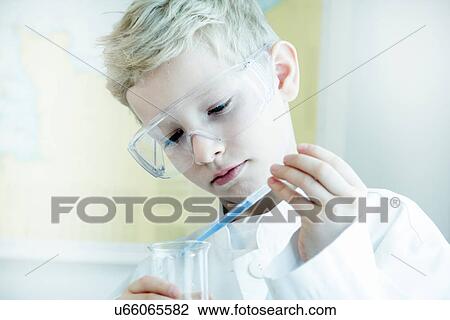Boy wearing safety goggles doing science experiment View Large Photo Image Stock Image - Boy wearing safety goggles doing science experiment. Fotosearch