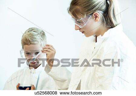 Brother and sister wearing safety goggles doing science experiment View Large Photo Image Stock Photo - Brother and sister wearing safety goggles doing science experiment. Fotosearch