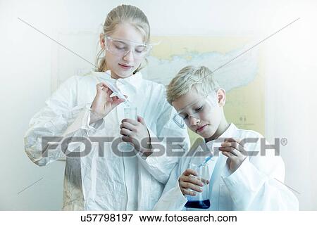 Brother and sister wearing safety goggles doing science experiment View Large Photo Image Stock Photo - Brother and sister wearing safety goggles doing science experiment. Fotosearch