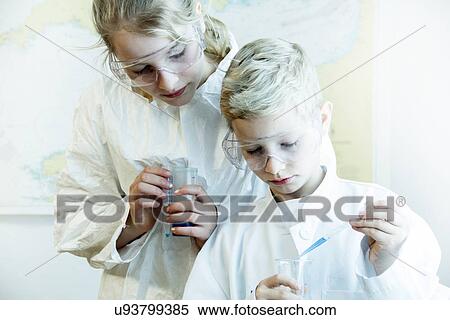 Brother and sister wearing safety goggles doing science experiment View Large Photo Image Stock Photography - Brother and sister wearing safety goggles doing science experiment. Fotosearch