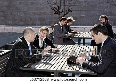 Business people working at outdoor tables View Large Photo Image Stock Photo - Business people working at outdoor tables. Fotosearch
