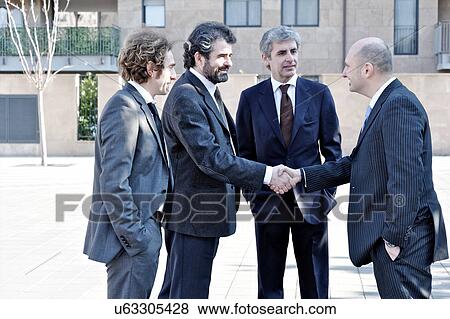 Businessmen shaking hands outdoors View Large Photo Image Stock Photo - Businessmen shaking hands outdoors. Fotosearch