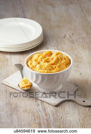 Carrot, swede and potato mash in rustic white bowl with large metal spoon View Large Photo Image Stock Photo - Carrot, swede and potato mash in rustic white bowl with large metal spoon. Fotosearch
