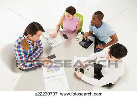 Casual business meeting, high angle View Large Photo Image Stock Photo - Casual business meeting, high angle. Fotosearch