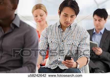 Stock Image - Casual businessman on cell phone. Fotosearch