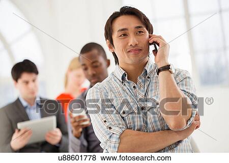 Stock Photo - Casual businessman on cell phone. Fotosearch