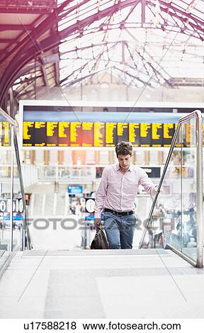 Casual businessman on escalator, London, England, UK View Large Photo Image Stock Photo - Casual businessman on escalator, London, England, UK. Fotosearch