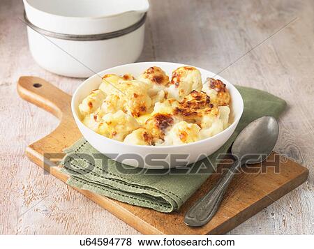 Stock Photo - Cauliflower cheese in white bowl with green napkin and spoon. Fotosearch