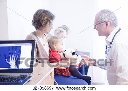 Child being examined by doctor, x-ray of hand in foreground View Large Photo Image Stock Photo - Child being examined by doctor, x-ray of hand in foreground. Fotosearch