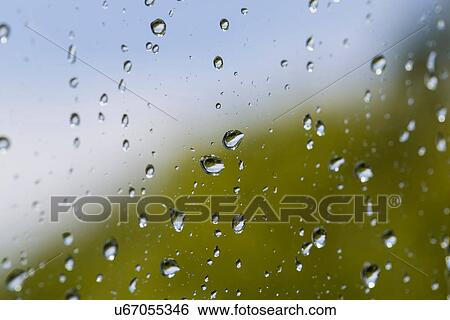 Stock Photograph - Close up of rain droplets on window. Fotosearch