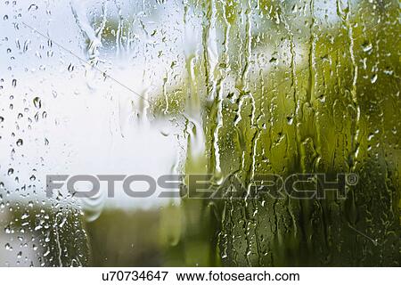 Close up of rain water running down window View Large Photo Image Stock Photo - Close up of rain water running down window. Fotosearch