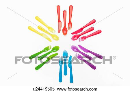 Stock Photography - Colourful plastic cutlery in a circle. Fotosearch