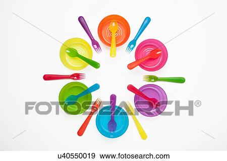 Stock Photo - Colourful plastic plates, cups, bowls, spoons and forks. Fotosearch