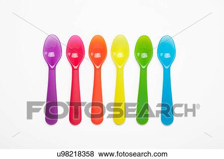 Colourful plastic spoons in a row View Large Photo Image Stock Photo - Colourful plastic spoons in a row. Fotosearch