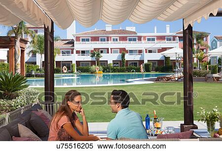 Couple relaxing at holiday resort View Large Photo Image Stock Photography - Couple relaxing at holiday resort. Fotosearch