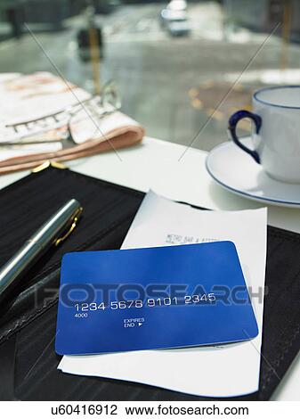 Stock Image - Credit card and bill on restaurant table. Fotosearch