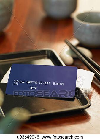 Stock Photograph - Credit card and bill on restaurant table. Fotosearch