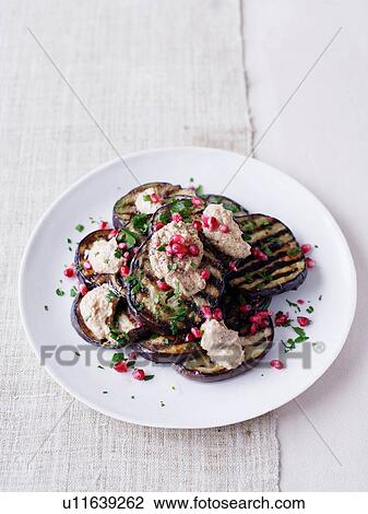 Stock Image - Eggplant salad with pomegranate seeds. Fotosearch