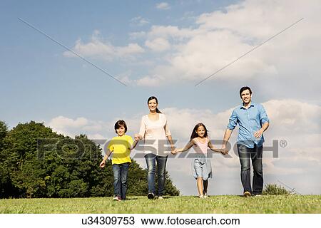 Family with two children holding hands, walking View Large Photo Image Stock Image - Family with two children holding hands, walking. Fotosearch