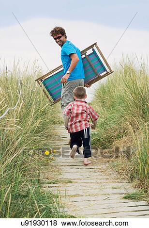 Stock Photo - Father and boy heading for the beach. Fotosearch