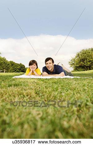 Father and son lying on blanket View Large Photo Image Stock Photo - Father and son lying on blanket. Fotosearch