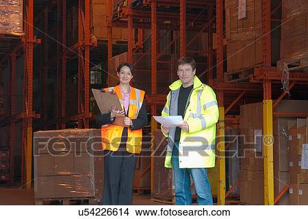 Female and male workers in warehouse View Large Photo Image Picture - Female and male workers in warehouse. Fotosearch
