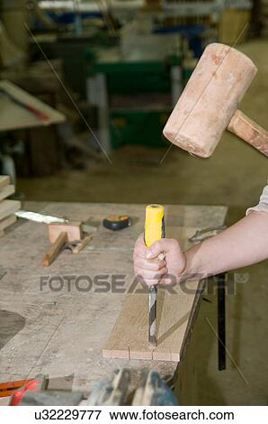 Stock Photo - Female carpenter at work. Fotosearch