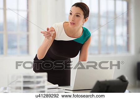 Female office worker using laptop View Large Photo Image Stock Image - Female office worker using laptop. Fotosearch