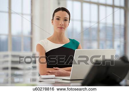 Female office worker using laptop View Large Photo Image Stock Photograph - Female office worker using laptop. Fotosearch