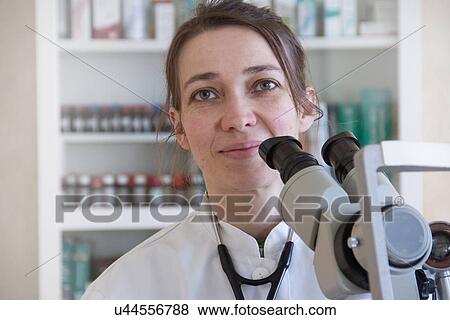 Female scientist using microscope View Large Photo Image Stock Photo - Female scientist using microscope. Fotosearch