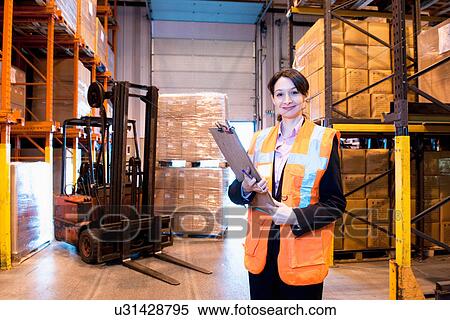 Stock Photography - Female supervisor in warehouse. Fotosearch