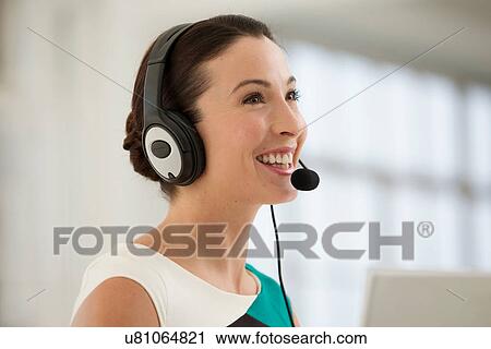 Female telephonist wearing headset View Large Photo Image Stock Image - Female telephonist wearing headset. Fotosearch